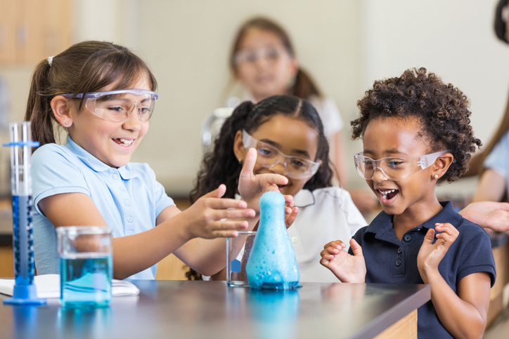 A group of children in our chemistry room, exploring the wonders of mixing different elements together to see what the results will be.