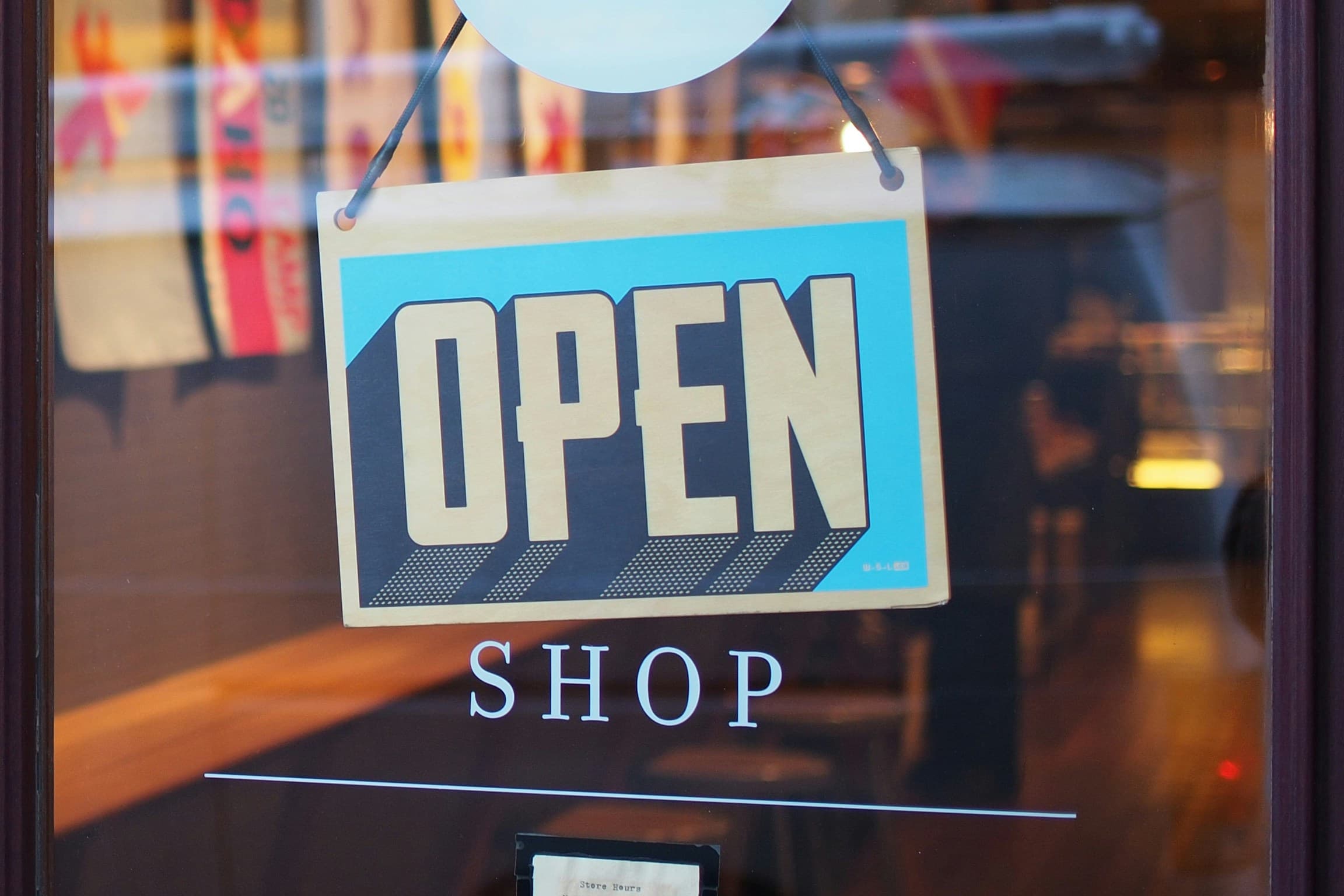 An open sign on the Museum shop window.