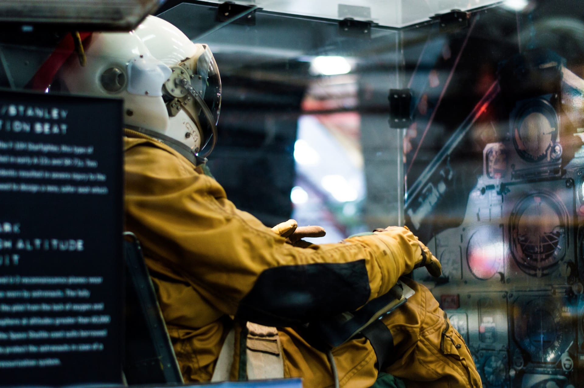 A person sitting in a rocket simulator at the science museum.