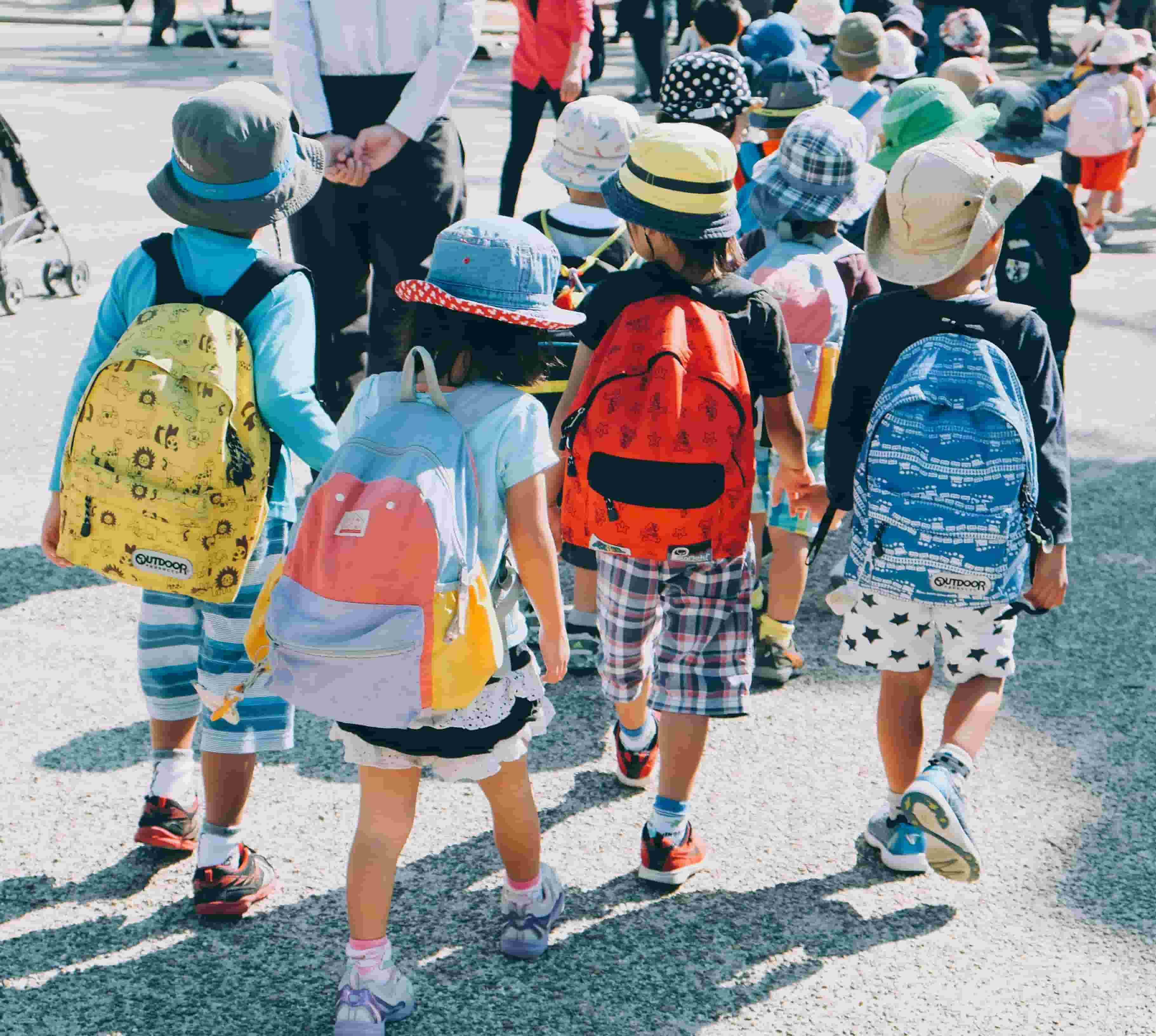 A group of children on a school trip walking together.